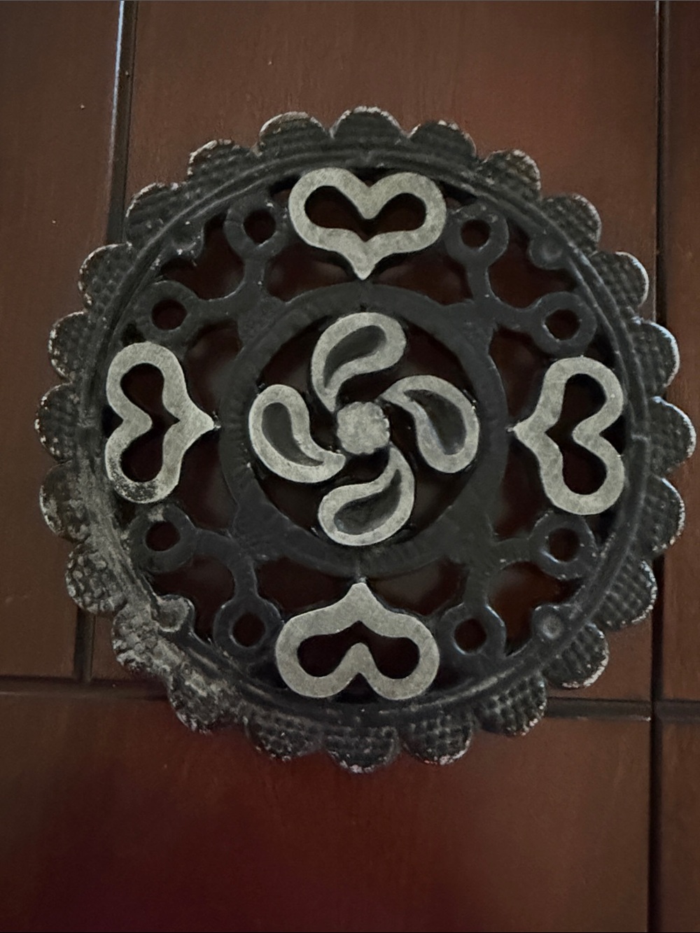 Vintage cast iron trivet, mid-20th-century piece featuring an ornate pattern